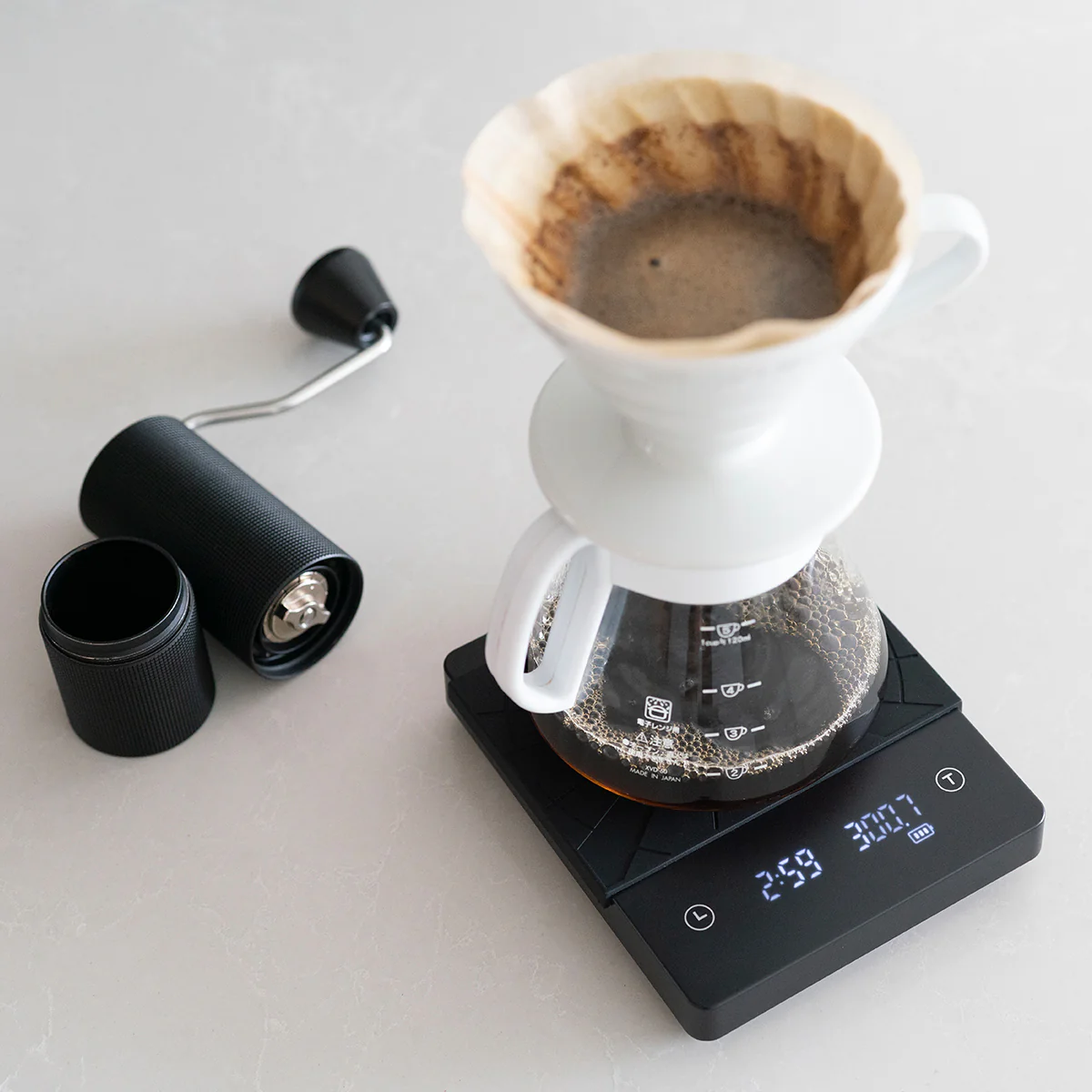 pour over coffee on a coffee scale with coffee grinder